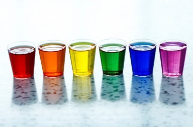 Multi-colored liquids in shot glasses