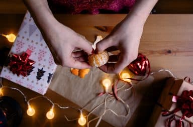 Wrapping an orange as a Christmas gift