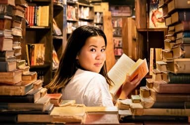 Woman with a sly smile in a bookstore