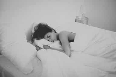 Woman lying awake in bed
