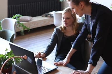 Women in office looking at a laptop