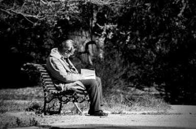 man reading a book alone