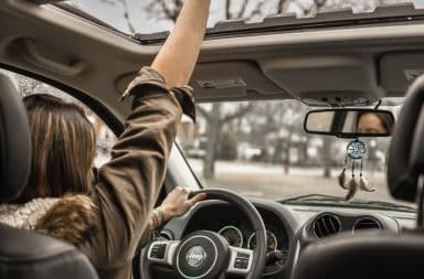 Woman with road rage and her hand out of the sunroof