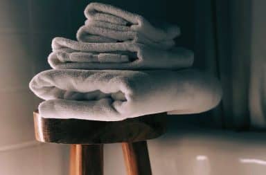 Hotel towels folded up on a stool