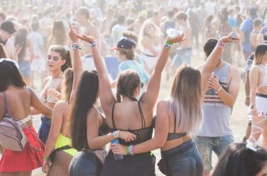 Music festival attendees partying outside in a small town