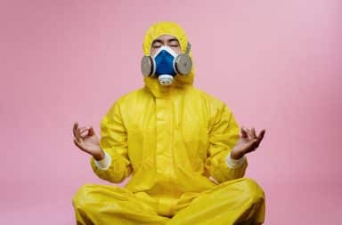 Man in hazmat suit meditating