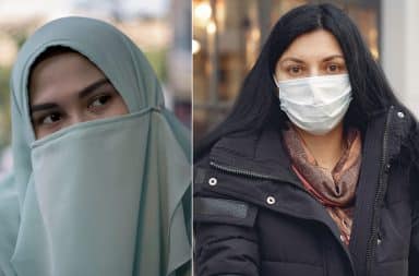 Veiled Muslim woman and woman wearing a medical face mask