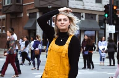 Woman scratching her head in the middle of the street