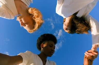 Women holding hands in a circle