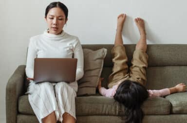 Work at home mom with child on couch