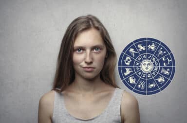 Woman looking smug with zodiac signs