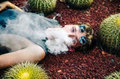 Man vaping next to cacti