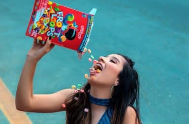 Froot Loops cereal being poured into mouth