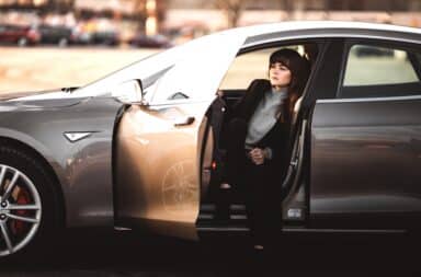 Woman in Tesla with driver door open