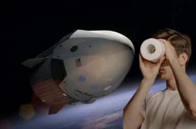 Man looking thru toilet paper roll at a spaceship