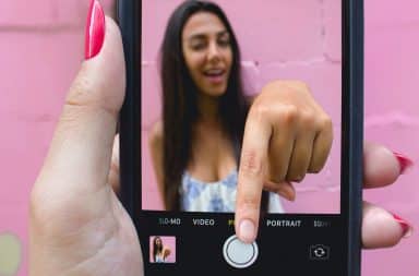 Woman pressing iPhone button