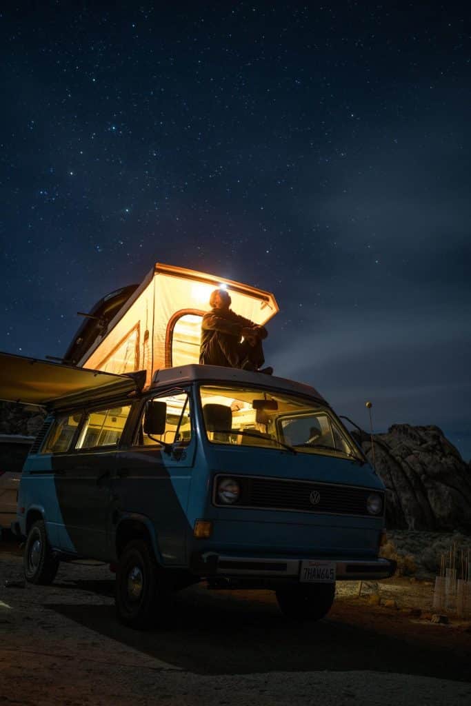 Camping van at night with moonroof open