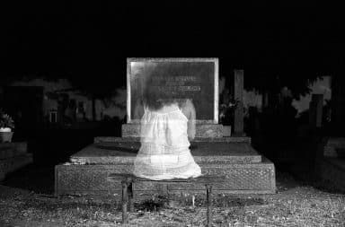 ghost in front of a gravestone