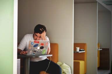 Man frustrated at his laptop