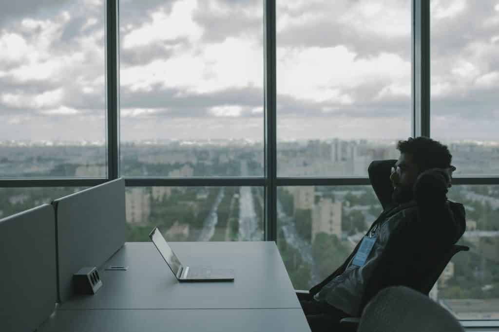 Man lounging in a highrise office