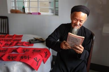 Man reading next to bed