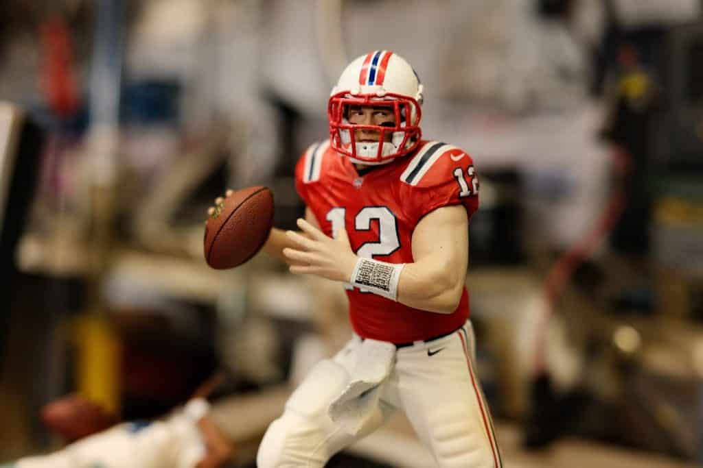 An NFL player wearing the number 12 red jersey