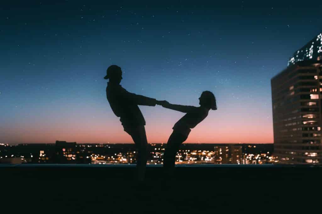 Couple swinging on a rooftop