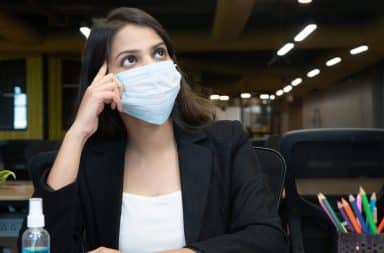 woman thinking while wearing a mask