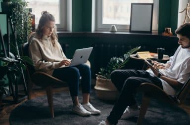 People at laptops searching while sitting