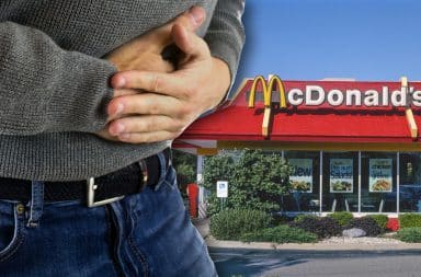 guy with a hurt tummy outside of mcdonalds