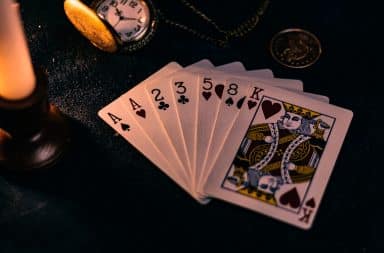 Playing cards on table with coin