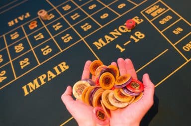 Chips at a casino table in hand