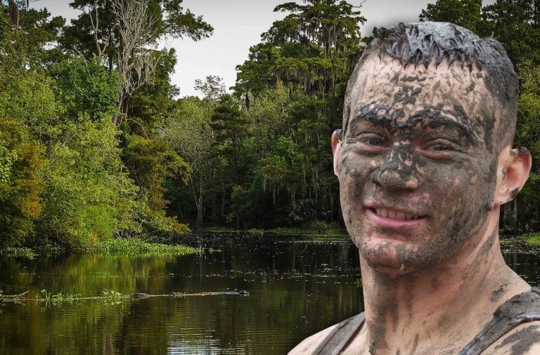 swamp man covered in mud