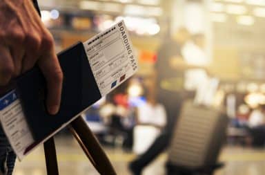 hand holding a boarding pass