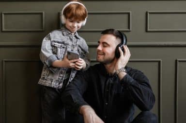 parent and kid listening to music