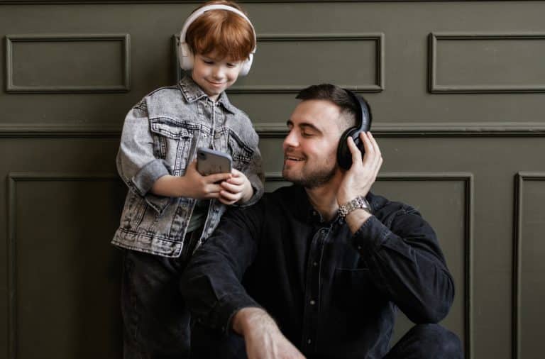 parent and kid listening to music