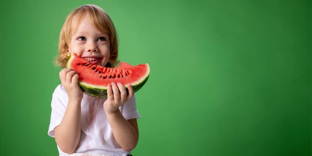 kid eats watermelon
