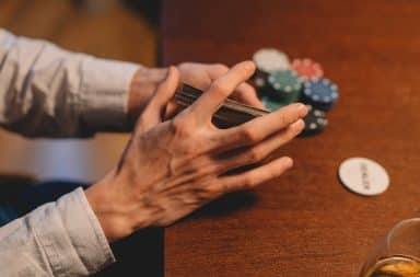 Hands on a deck of cards at the table