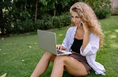 woman on a phone and a laptop wow