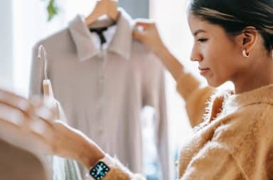 a woman looking at clothing