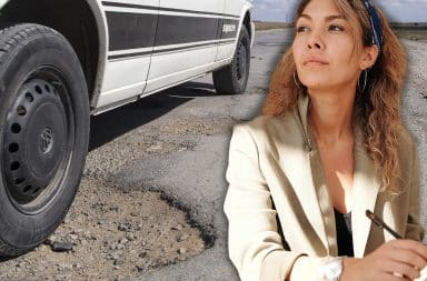 reporter investigating a pothole next to a car