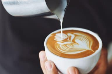 pouring milk into a latte