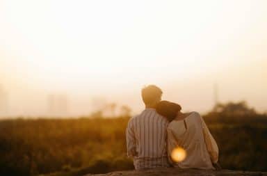 Couple at sunset sitting down