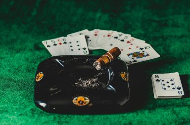 Casino cards by a cigar and ashtray