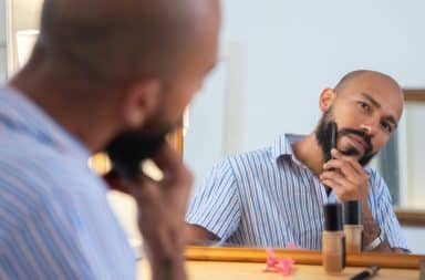 man combing beard