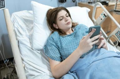 woman bed phone in the hospital