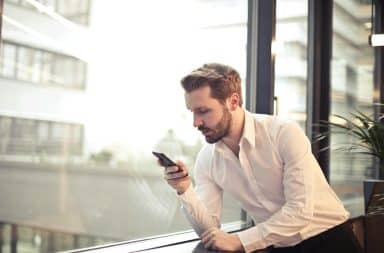 guy at work looking at his phone