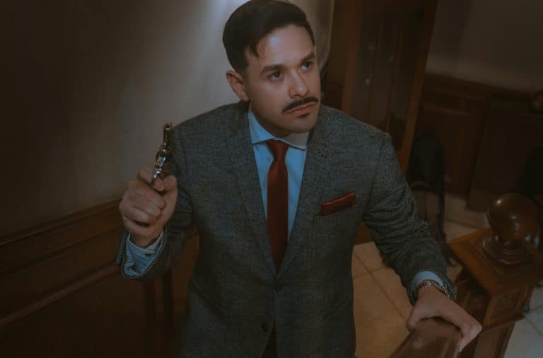 man in suit with gun