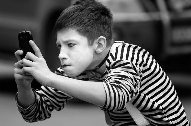 Mime looks at phone
