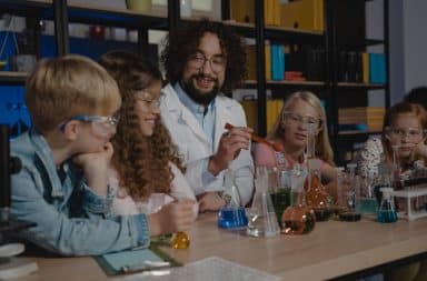 man doing science experiment with kids